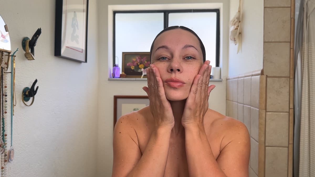 Shannon demonstrating a facial massage movement with her hands